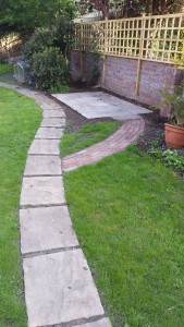 Paths and platform for greenhouse as part of a back garden design